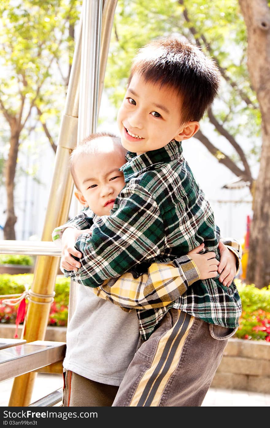 The brothers embraced each other in the park. The brothers embraced each other in the park