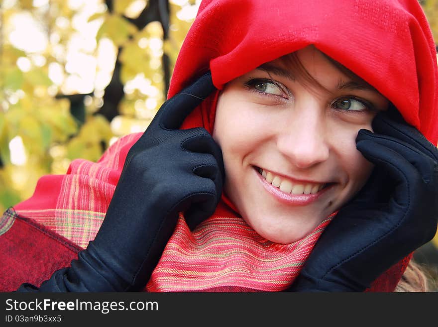 Closeup portrait of young beautiful girl in a red scarf. Closeup portrait of young beautiful girl in a red scarf