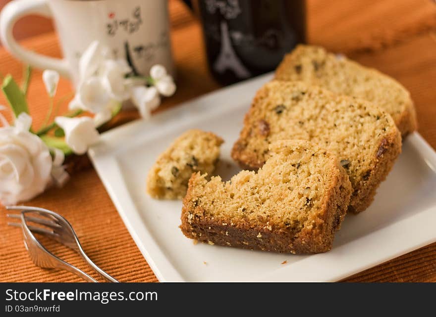 Cake on a saucer on the background of two cups with the words Paris. Cake on a saucer on the background of two cups with the words Paris.