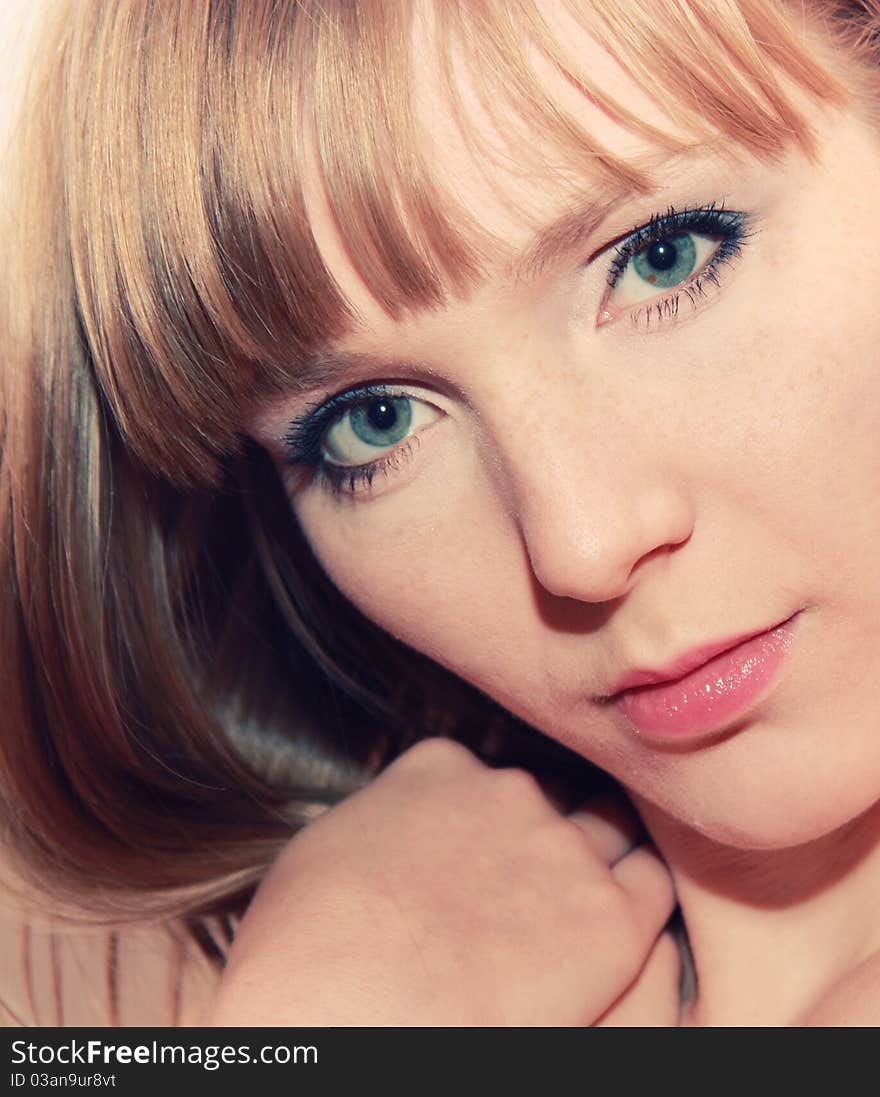 Closeup portrait of young blond beautiful girl