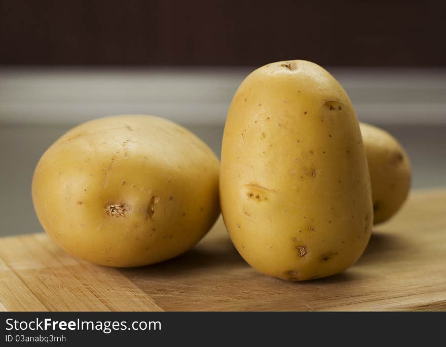 Group Of Potatoes Waiting On Breadboard