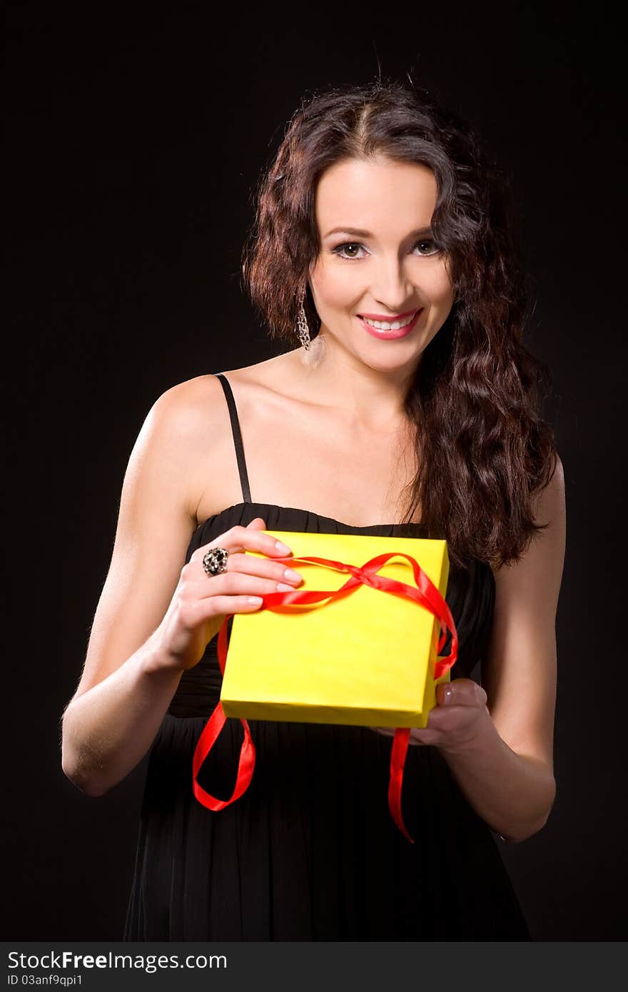 Surprised beautiful woman holding a gift. Surprised beautiful woman holding a gift