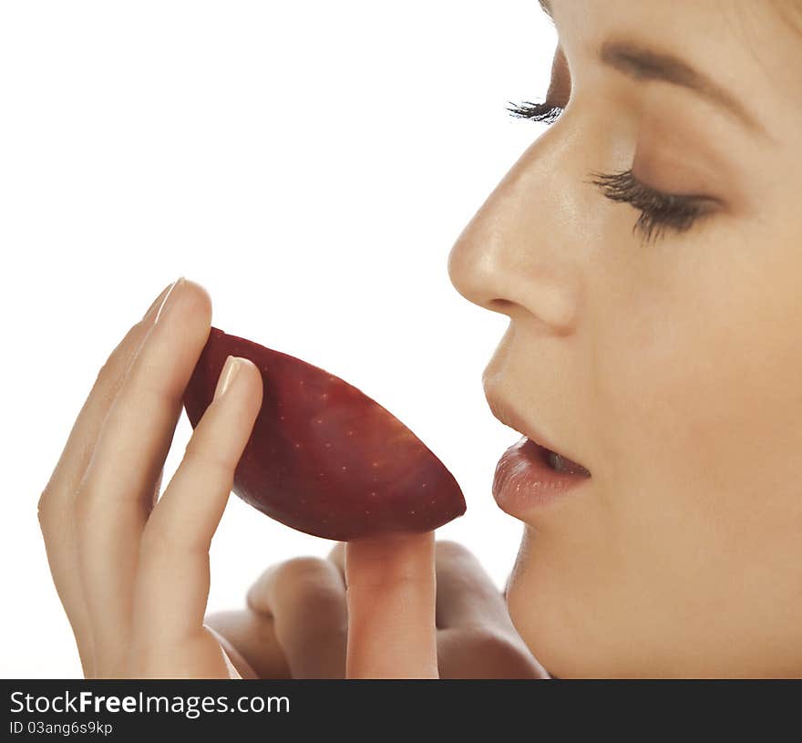 Young woman enjoying a piece of red apple