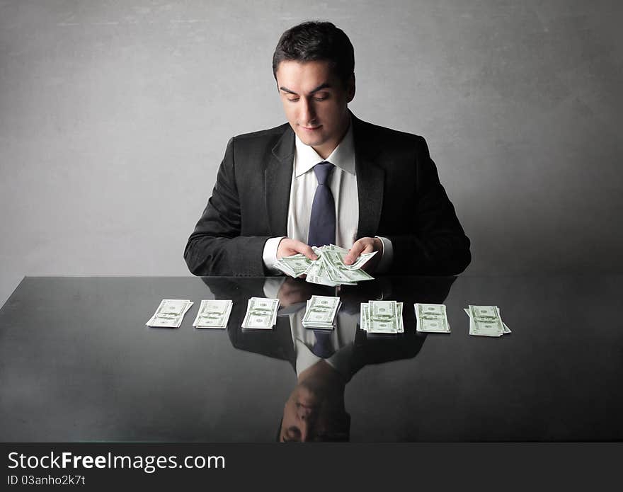 Businessman counting out some banknotes. Businessman counting out some banknotes