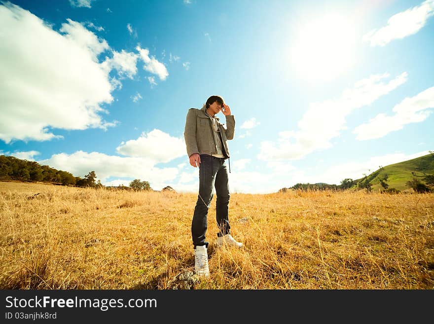 Young man rest on golden field. Young man rest on golden field.