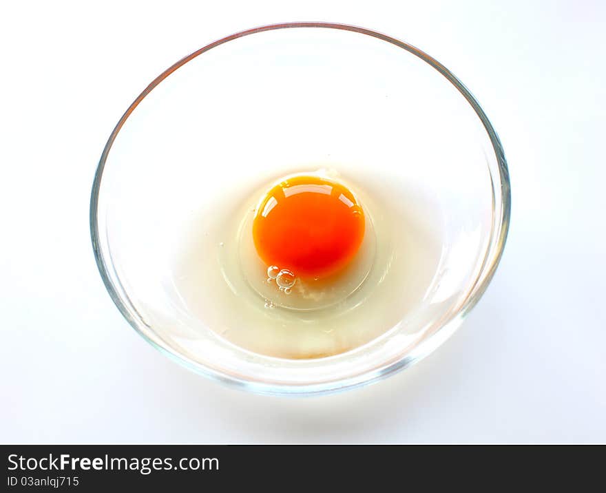 Broken chicken egg in the bowl as food ingredient