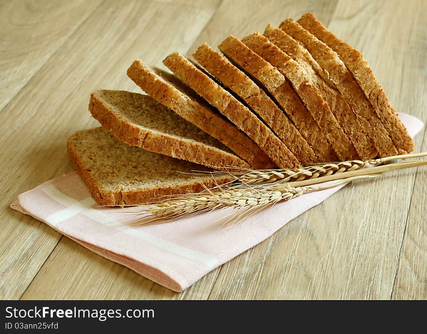 Bread and ears on wooden boards. Bread and ears on wooden boards