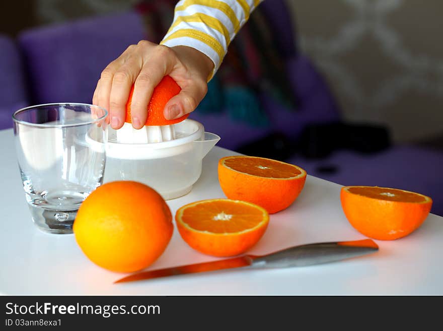 Squeezing oranges for orange juice in the morning for breakfast