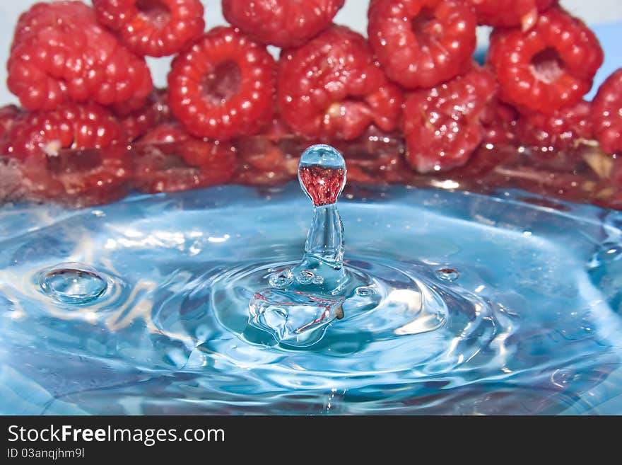 Raspberry dropped to clear blue water. Raspberry dropped to clear blue water.