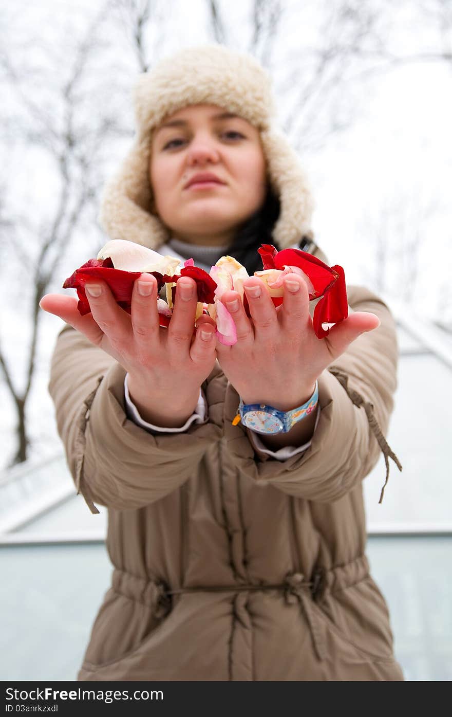 The girl holds out roses. The girl holds out roses