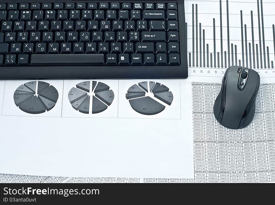 Black keyboard and mouse on a stock chart. Black keyboard and mouse on a stock chart.