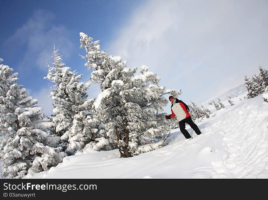 Portrait man of skier on a background snow-bound mountains and fir-trees, Carpathian Mountains, Dragobrat, Ukraine. Portrait man of skier on a background snow-bound mountains and fir-trees, Carpathian Mountains, Dragobrat, Ukraine