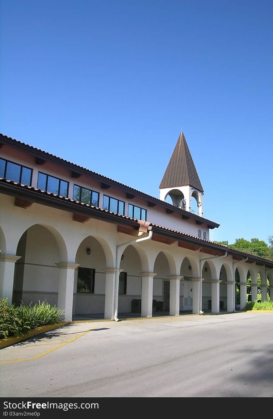 Arched walkway leading to a small church.