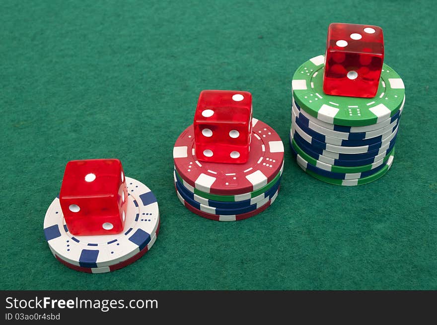 Dice and chips on a green table