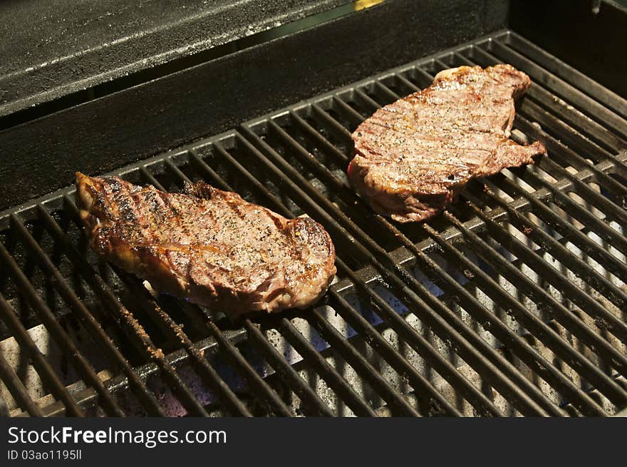 BBQ Steak on a grill at night time