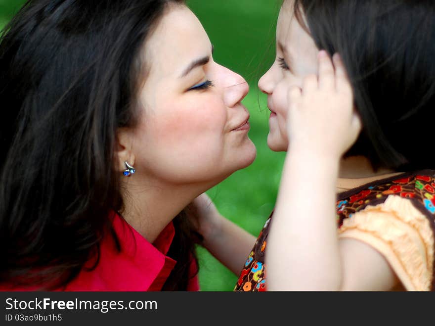 Mother and daughter kissing on the nose. Mother and daughter kissing on the nose