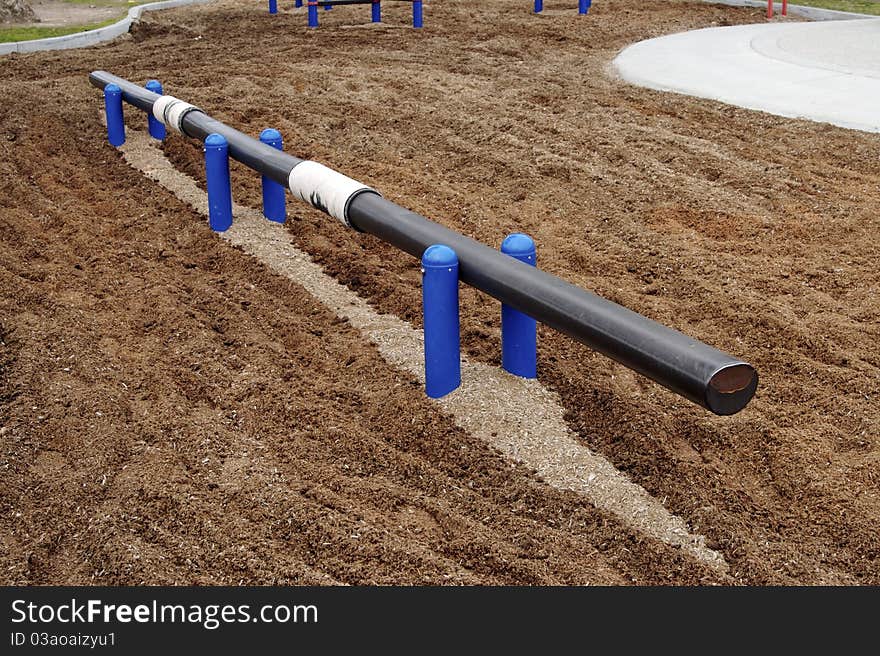 Balance beam and bark padding at playground park