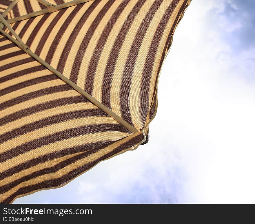 Detail of beach umbrella opposite sun light