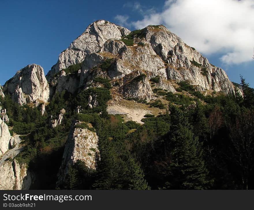 Stony mountain peak with blue sky in the background.