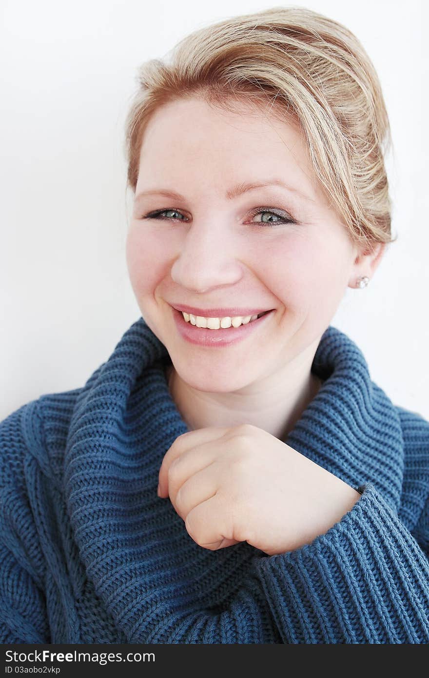 Young woman in the dark-blue sweater smiles