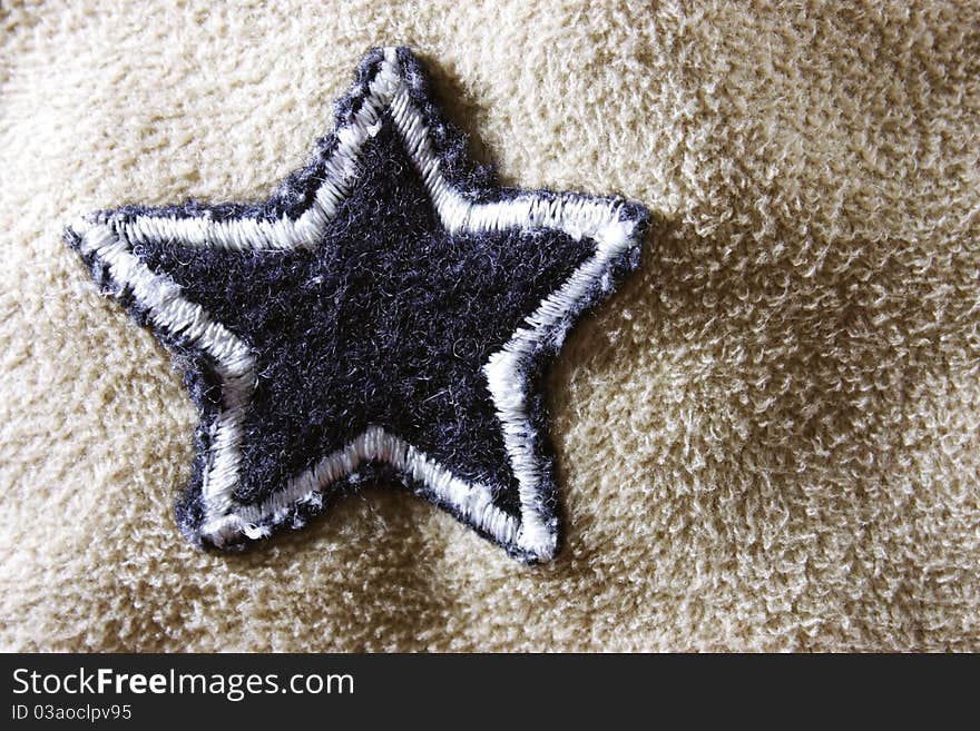 Soft fleece fabric with a star to be used as a background. Soft fleece fabric with a star to be used as a background