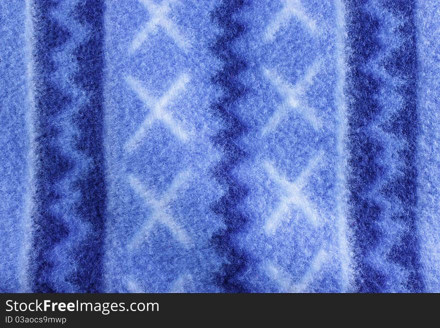 Warm blue fleece patterned blanket to be used as a background. Warm blue fleece patterned blanket to be used as a background