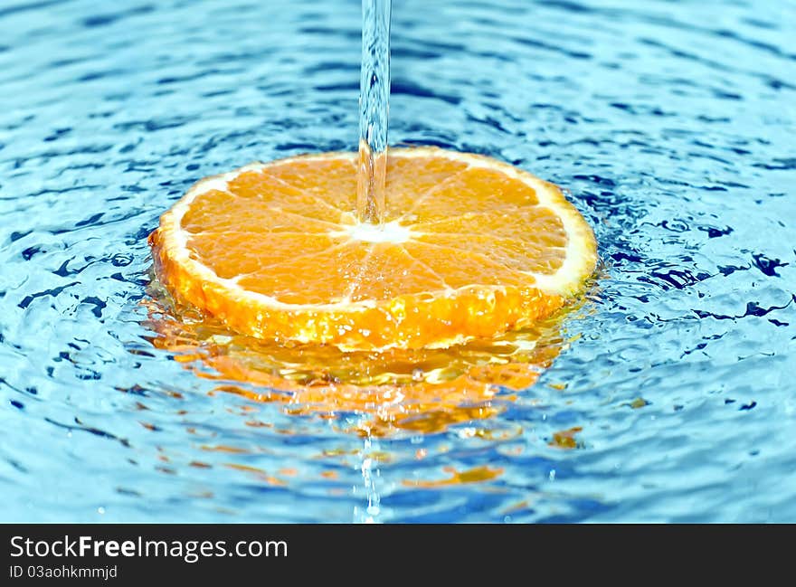 Fresh orange in water splash