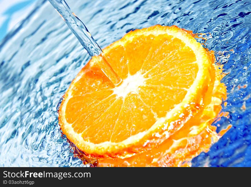 Fresh orange in water splash