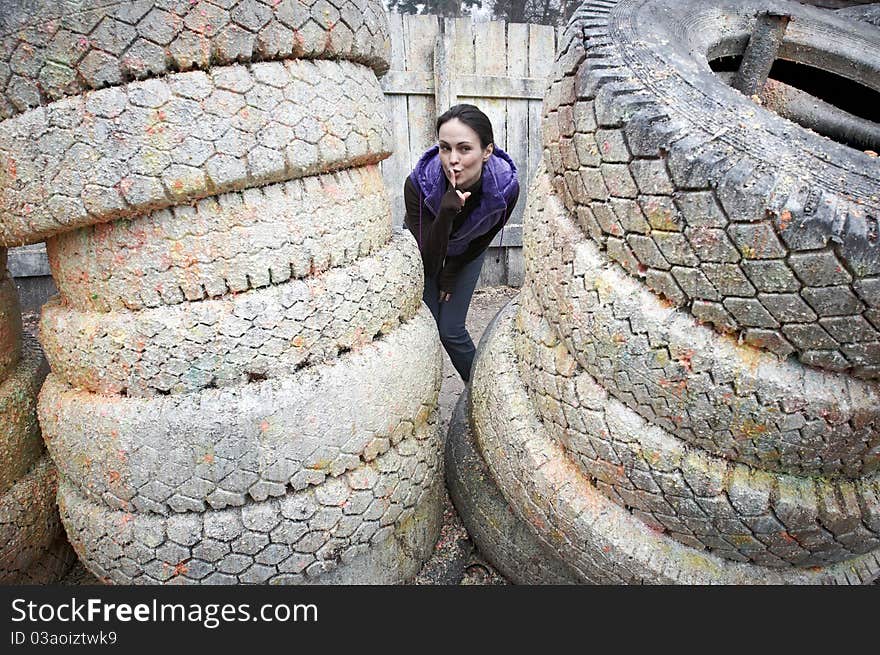 Girl playing Paintball game and hiding herself. Girl playing Paintball game and hiding herself