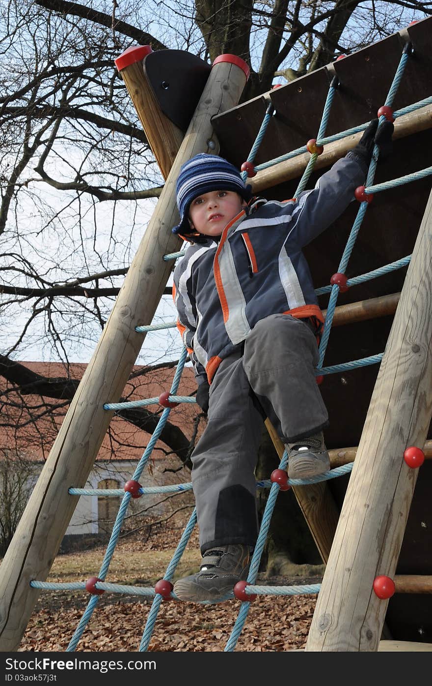 Child standing on rope ladder