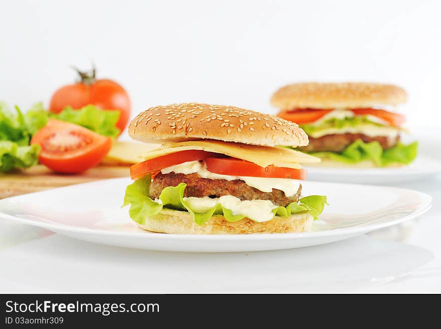 Hamburger with cutlet and vegetables on dish