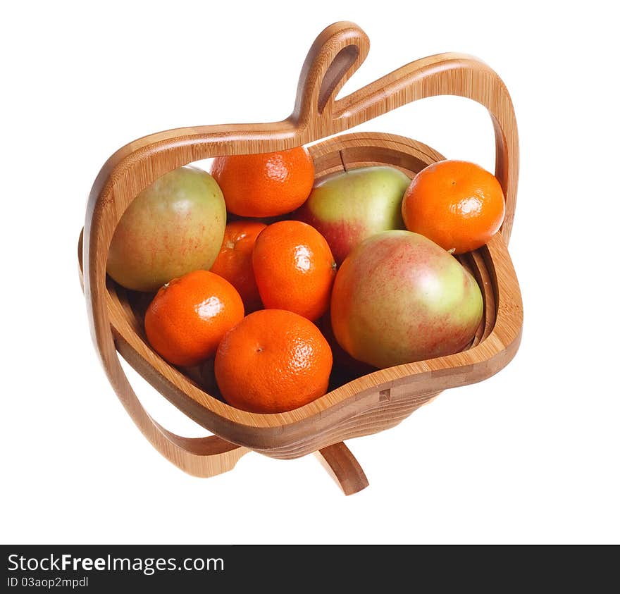 Tangerines and apples in a wooden basket isolated on a white background.