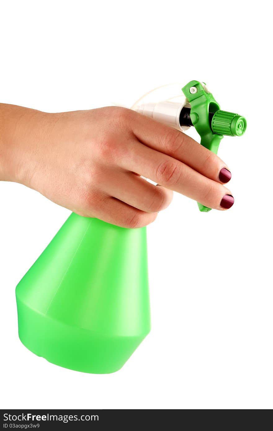 Hand of a young female holding the green sprayer for flowers. Hand of a young female holding the green sprayer for flowers