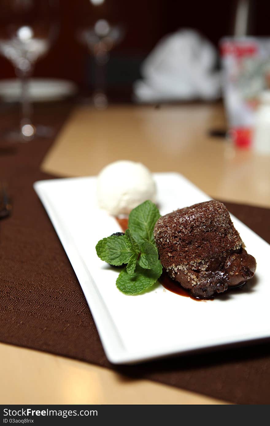 Chocolate Dessert on a square dish with fresh mint and ice cream. Chocolate Dessert on a square dish with fresh mint and ice cream