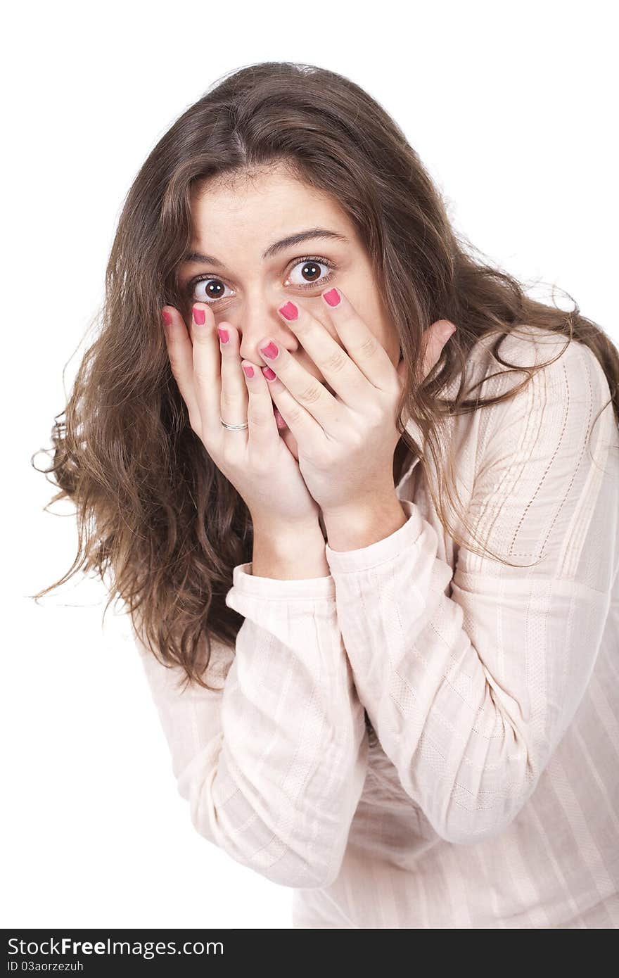 Portrait of a surprised young woman with hands over her mouth. Portrait of a surprised young woman with hands over her mouth