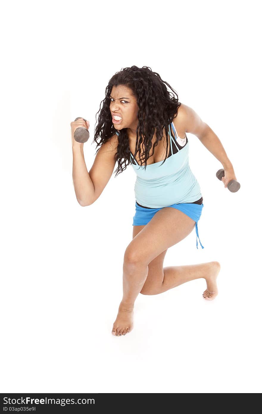 An African American woman is working out with a crazy expression. An African American woman is working out with a crazy expression.