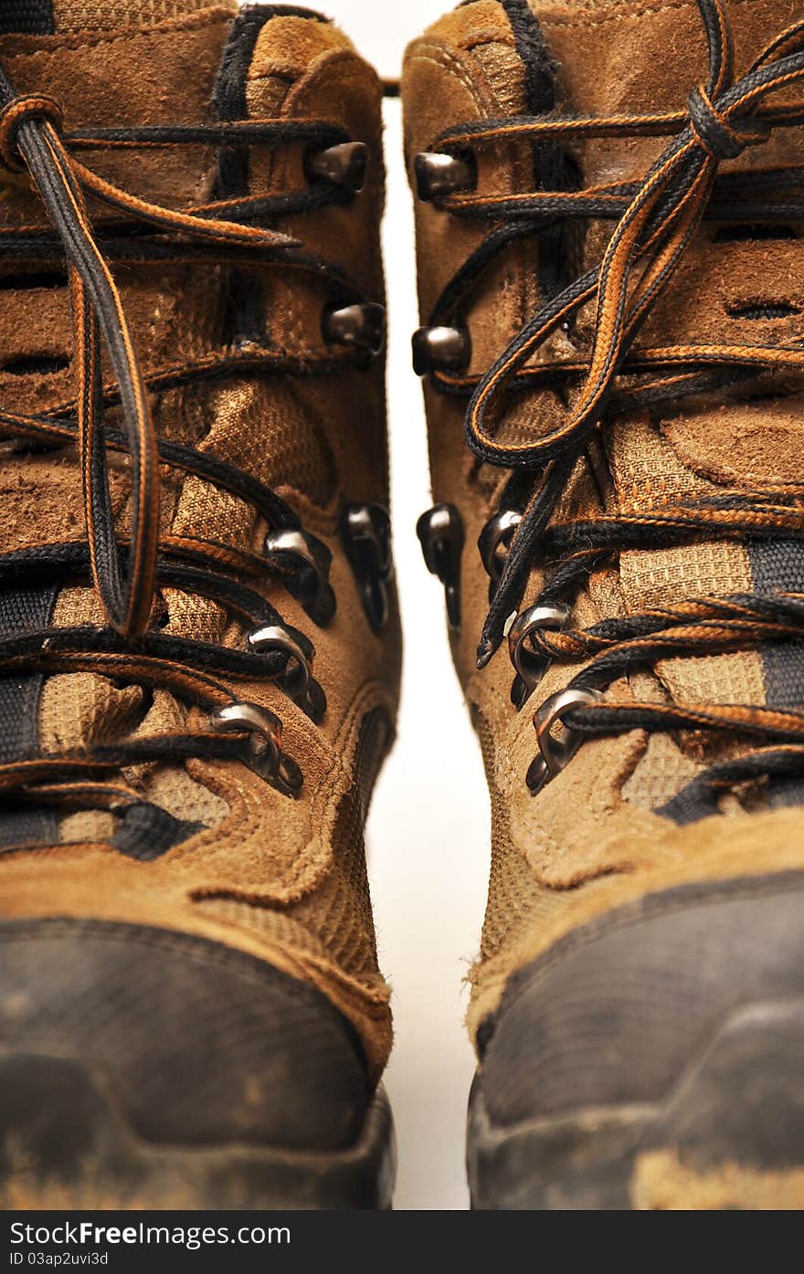 Trekking shoes and a white background