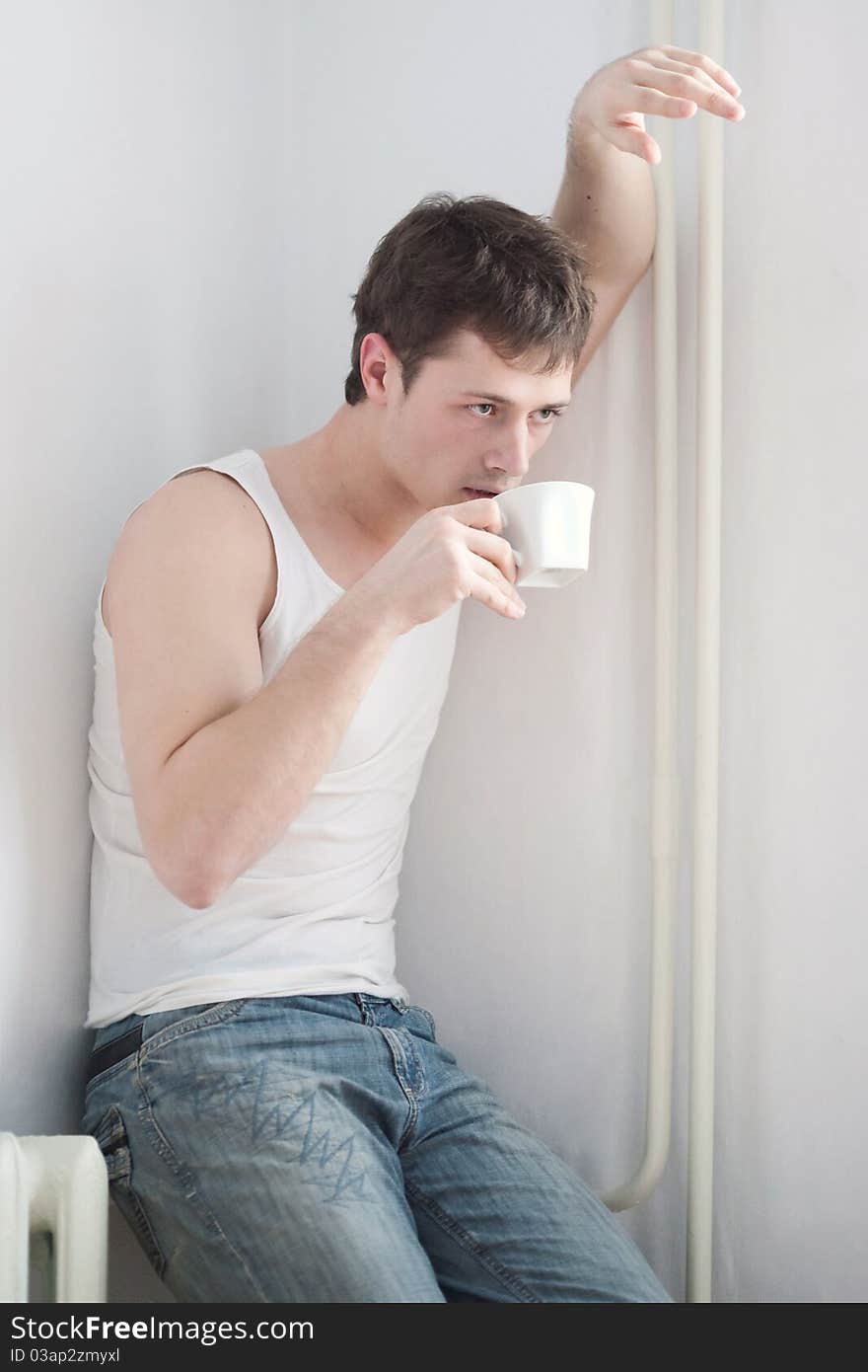 Portrait of a young man with a cup