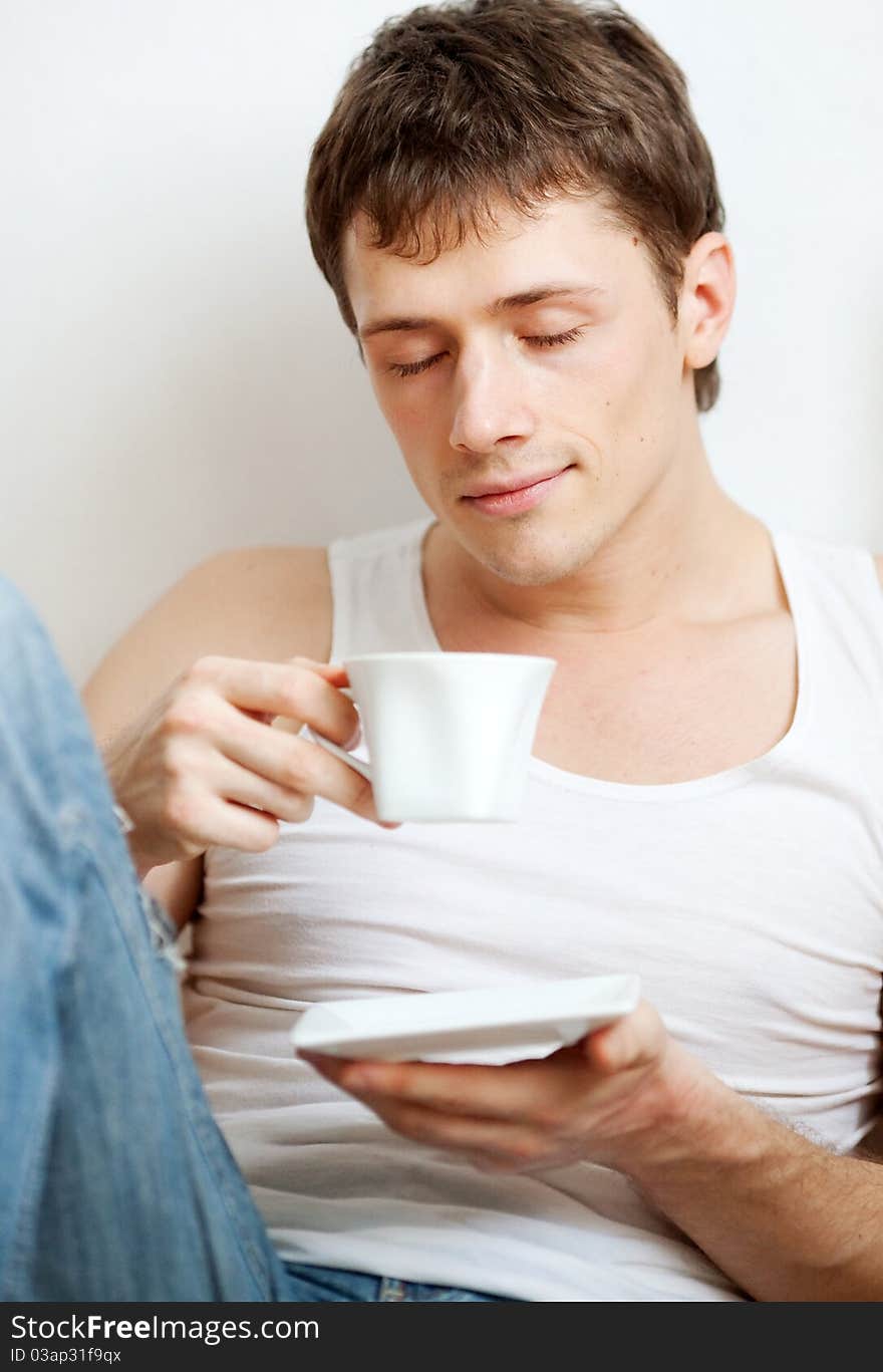 Portrait of a young man with a cup