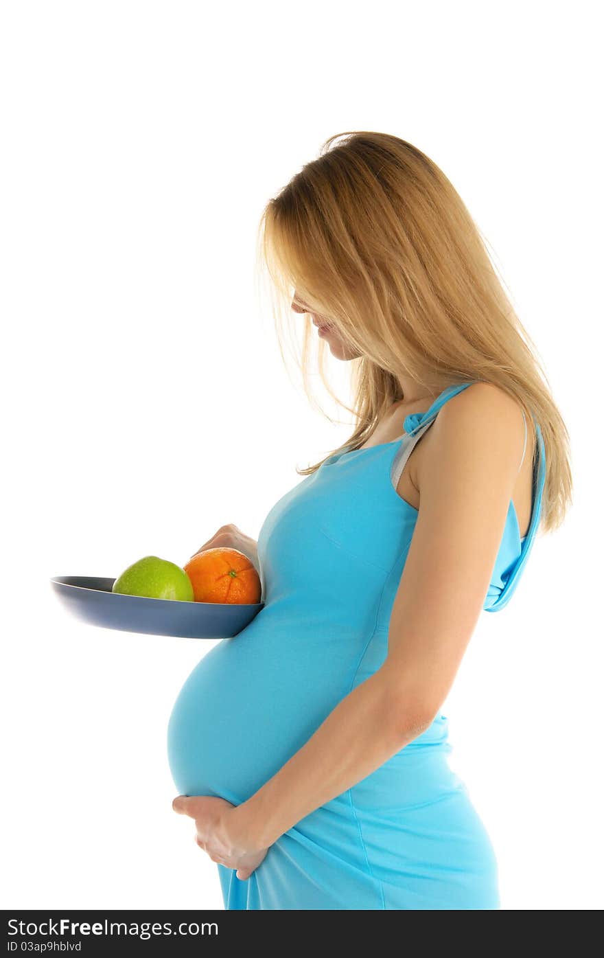 Pregnant woman holding an apple and an orange in a pan isolated on white. Pregnant woman holding an apple and an orange in a pan isolated on white