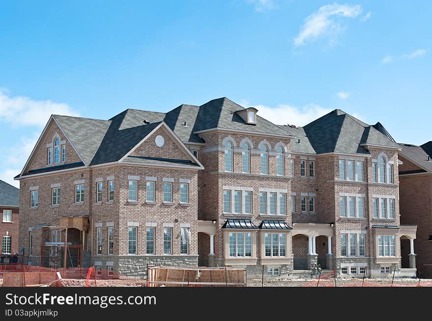 A newly built row of townhouses nears completion. A newly built row of townhouses nears completion.