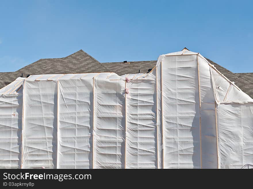 A heated plastic enclosure allows bricks to be laid during the cold winter months. A heated plastic enclosure allows bricks to be laid during the cold winter months.