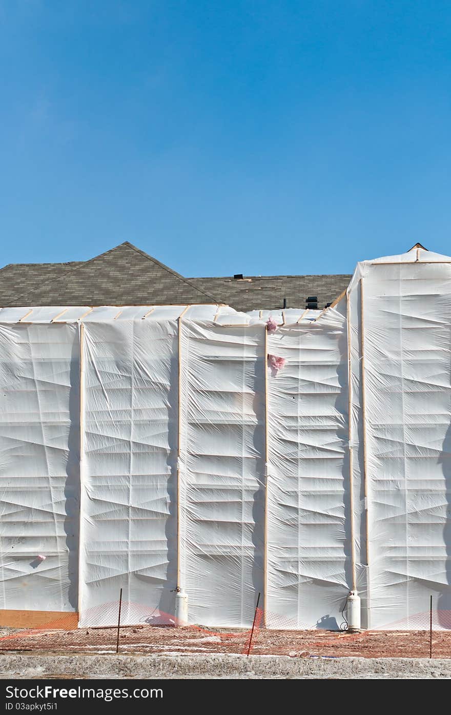 A heated plastic enclosure allows bricks to be laid during the cold winter months. A heated plastic enclosure allows bricks to be laid during the cold winter months.