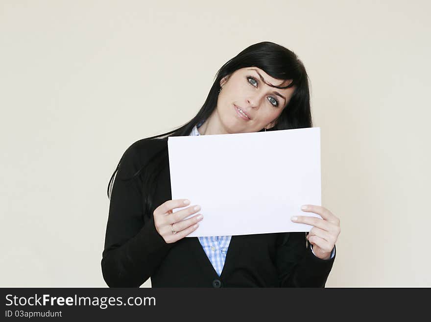 Business woman holding with both hands a white paper smiling looking at the camera. Business woman holding with both hands a white paper smiling looking at the camera