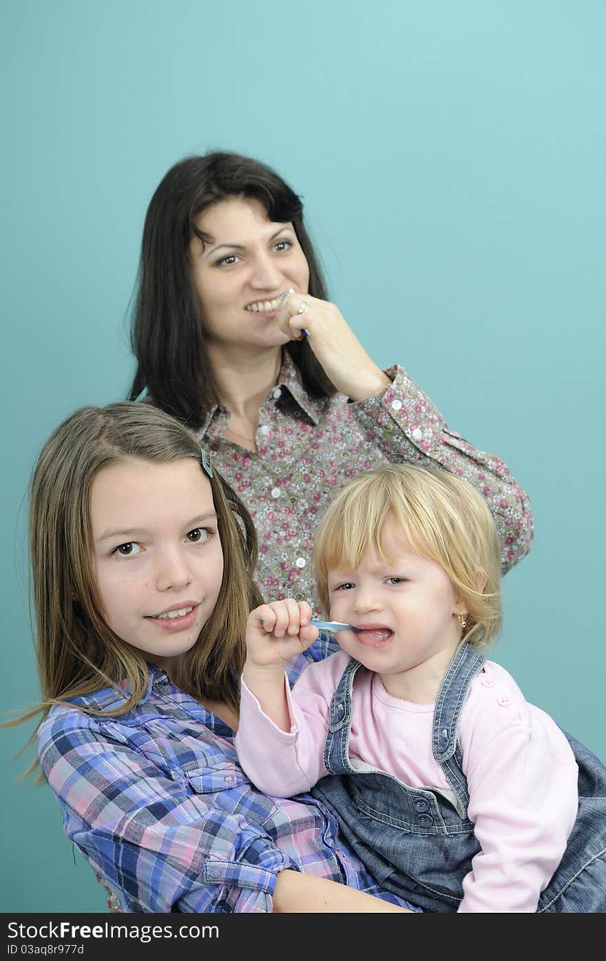 White child and teenager studying brushing tooth and mother teaching. White child and teenager studying brushing tooth and mother teaching