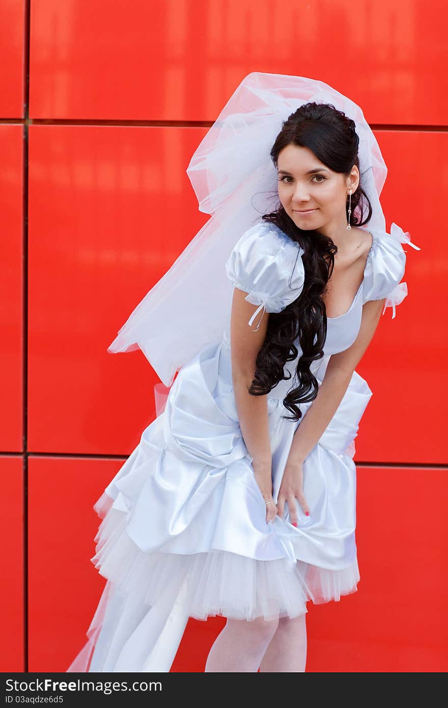 Bride by the red wall