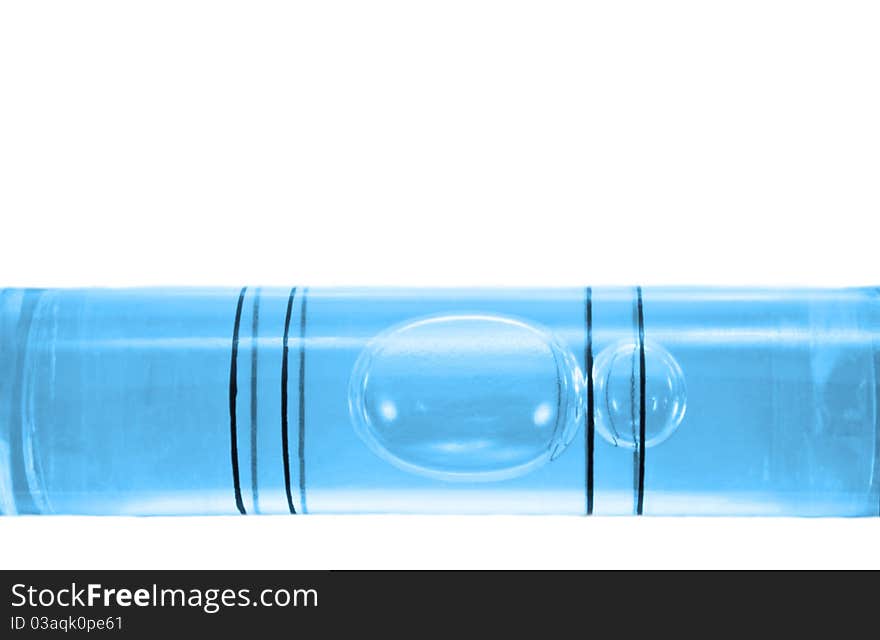 Close up on a the bubble of a blue spirit level arranged over white