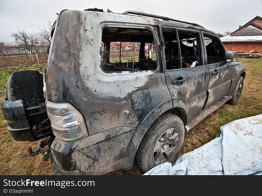 Burned car and left in a field