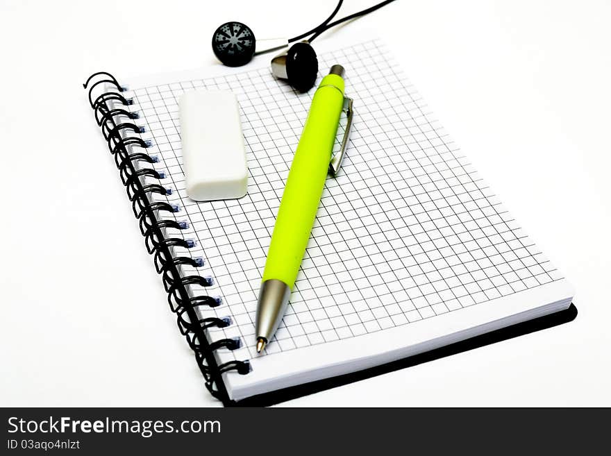 Photo of a notepad, the pen, earphones and a flash card. Photo of a notepad, the pen, earphones and a flash card.