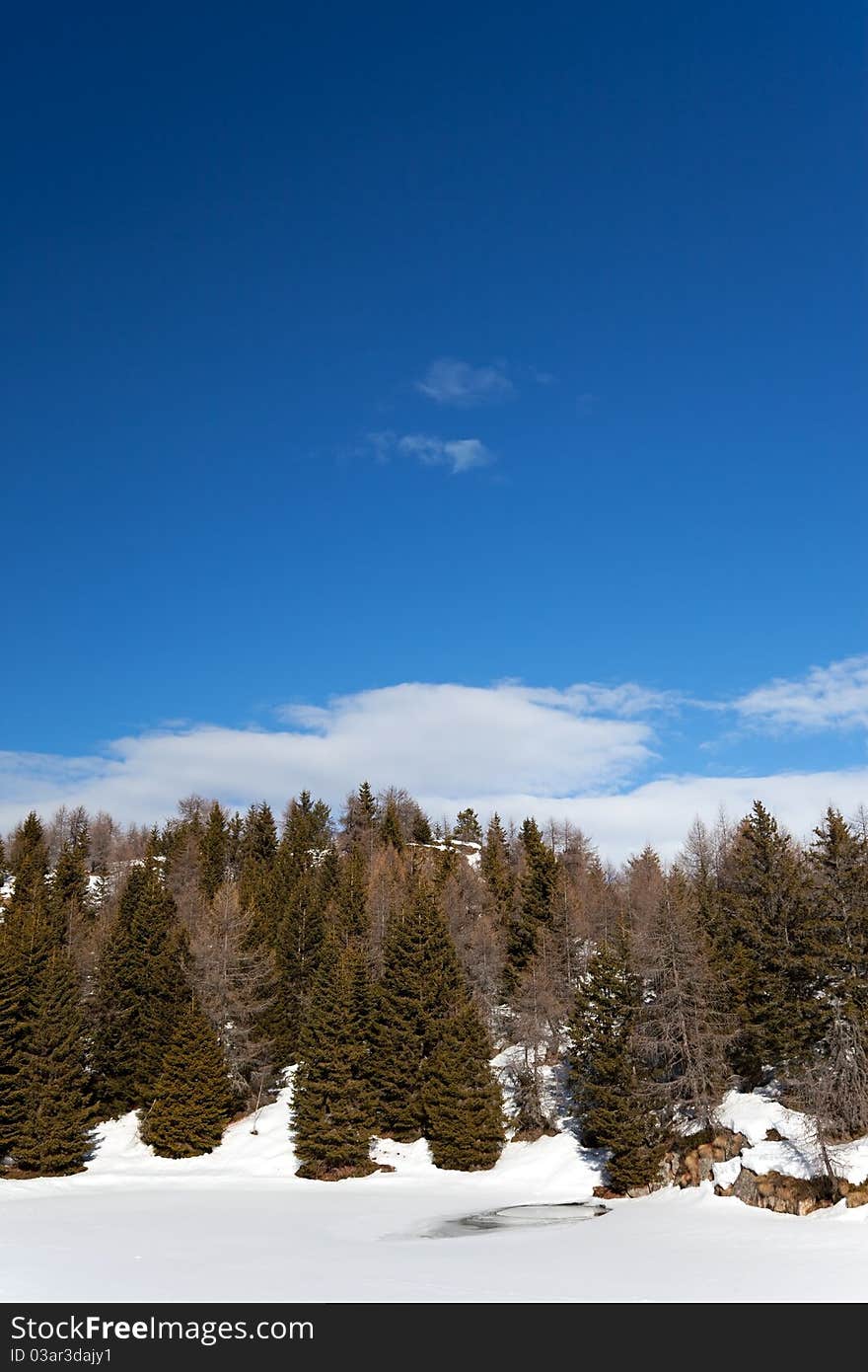 A small icy mountain lake after a frozen winter night. Brixia province, Lombardy region, Italy. A small icy mountain lake after a frozen winter night. Brixia province, Lombardy region, Italy